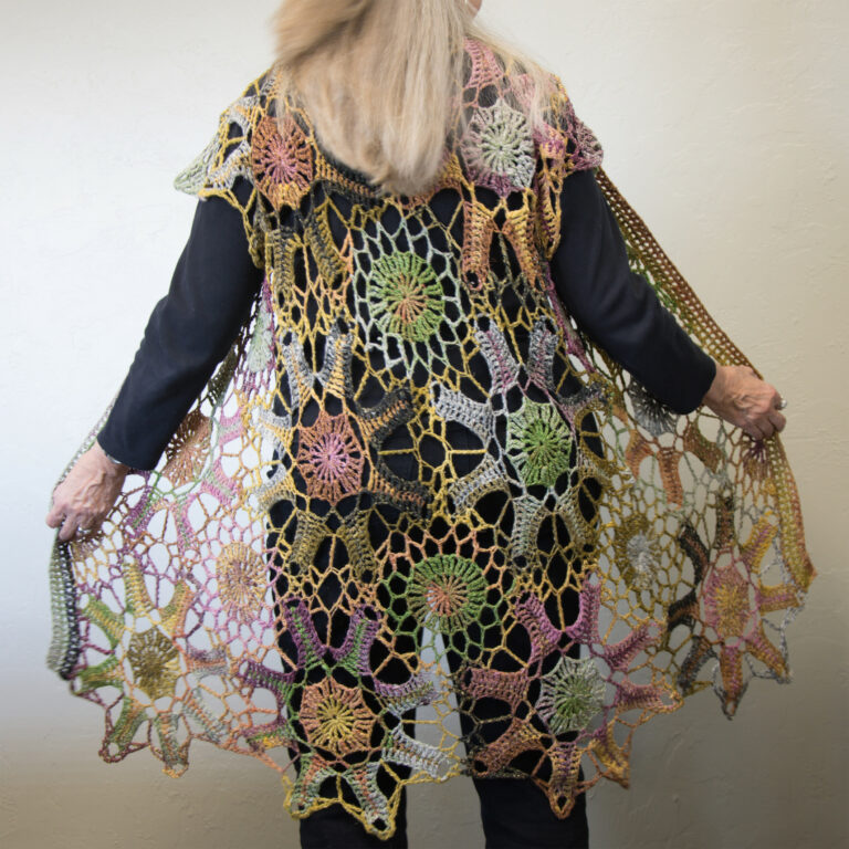 A long crochet lace vest in a colorful silk blend