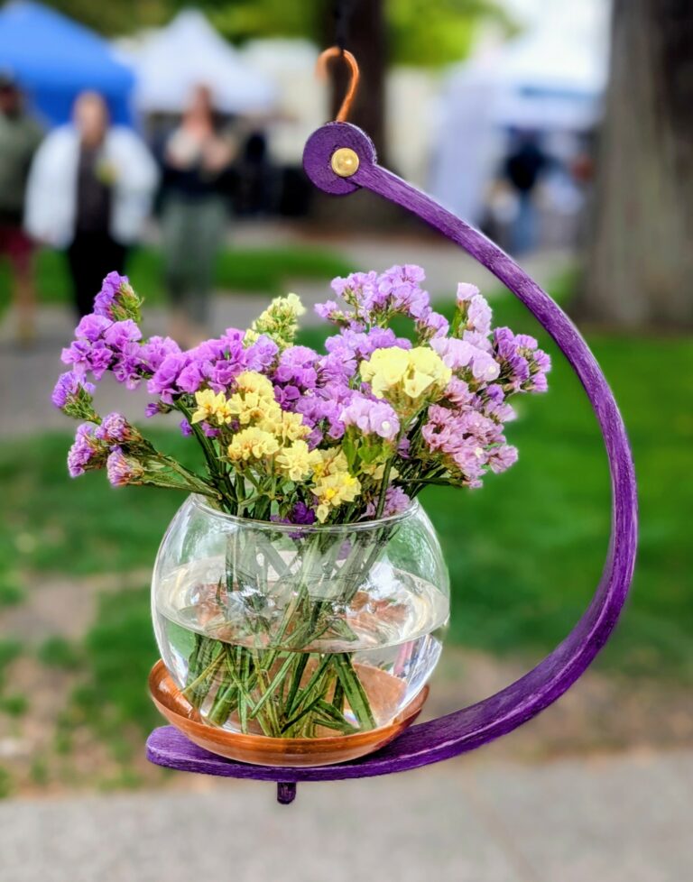 purple bentwood plant display, purple and yellow statis flowers