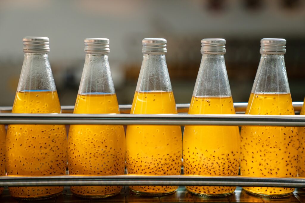 Juice in glass bottles in a factory for the food industry.