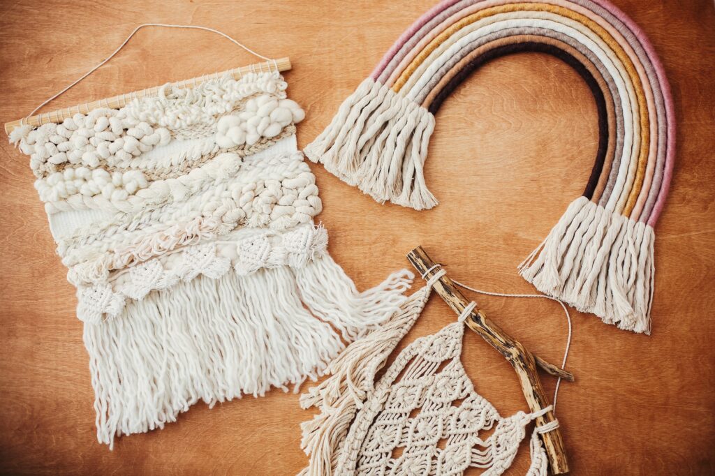Stylish macrame and rainbow decoration on wooden table