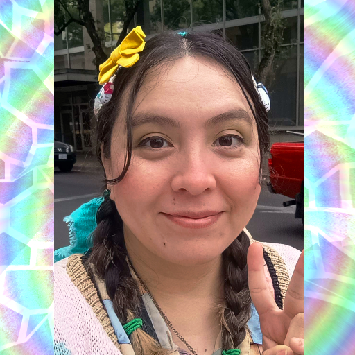 Featured in photo is the sewist Nelly. She has her dark hair in twin braids, adorned with a Nelly's Novelties yellow, hair bow. She is smiling at the camera and is displaying the peace sign gesture with her left hand. On the sides of the original photo is a digital pastel rainbow with white glass-like cracks created by Nelly using an opensource program, not AI.